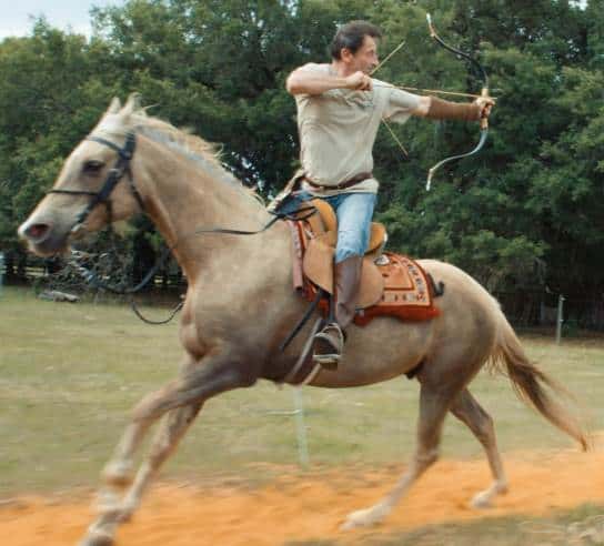 A modern mounted archer with a short horsebow