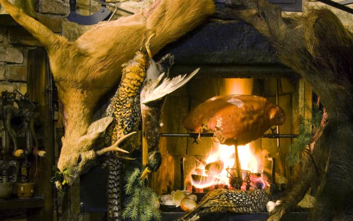 Venison hanging in front of a fire